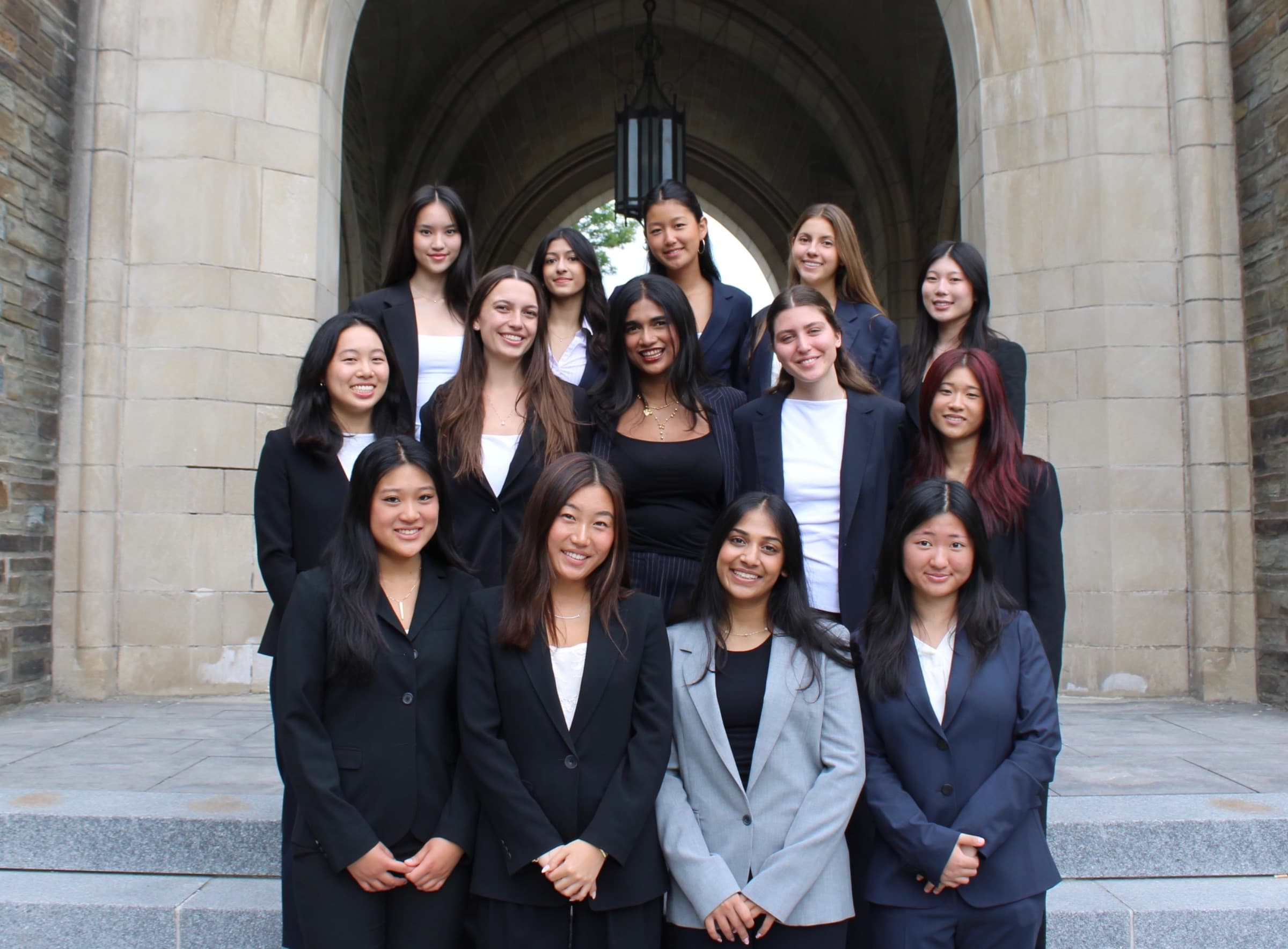 Women of the chapter gathered beneath the arch